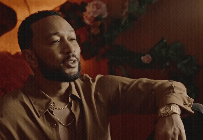 a man sitting in a chair with a watch on his wrist