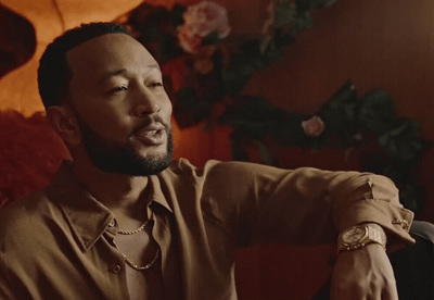 a man sitting in a chair with a watch on his wrist