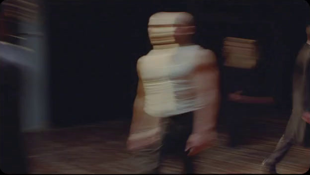 a blurry image of a person walking in a room