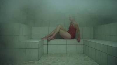 a woman in a red bathing suit sitting on a ledge