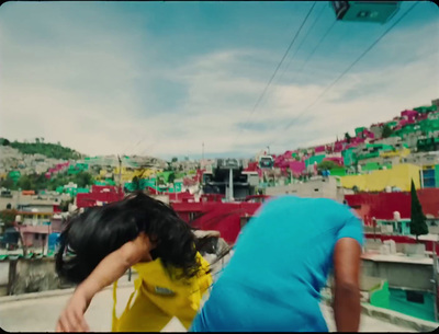 a couple of people standing on top of a roof