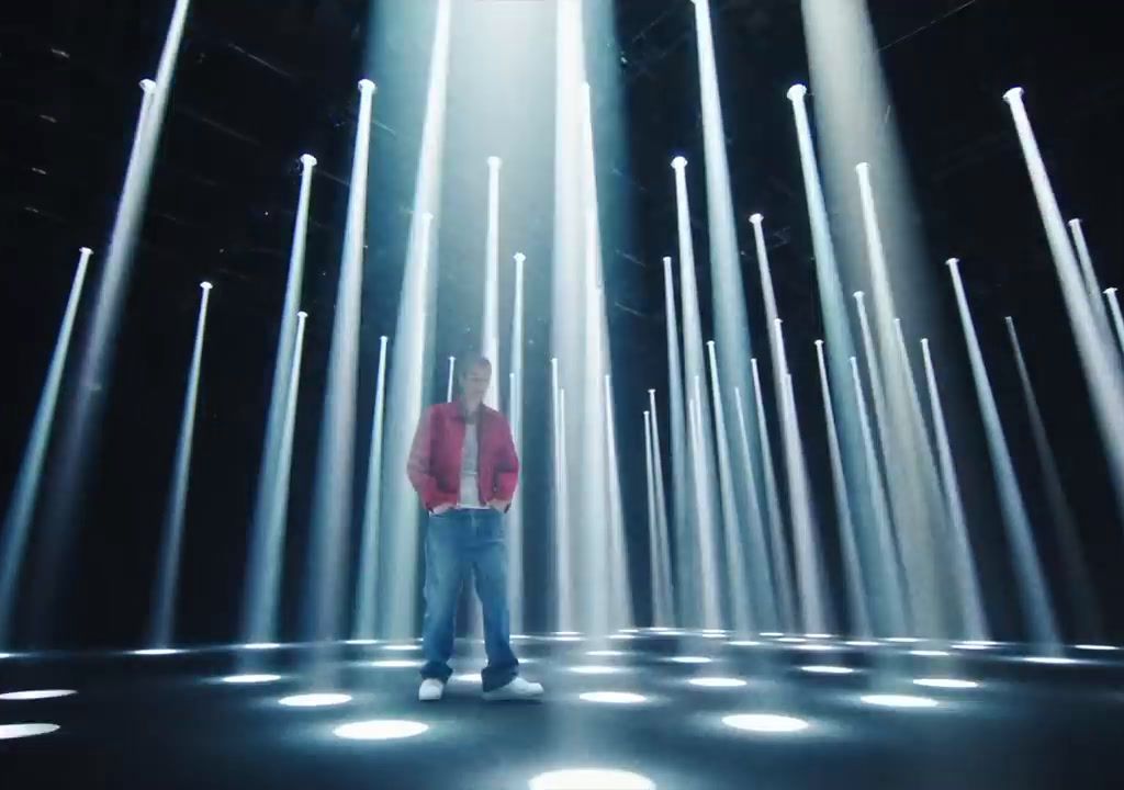 a man standing in front of a lot of white lights