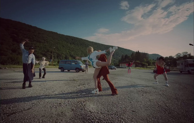 a group of people standing in a parking lot