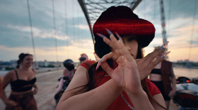 a woman wearing a red hat and holding her hands up