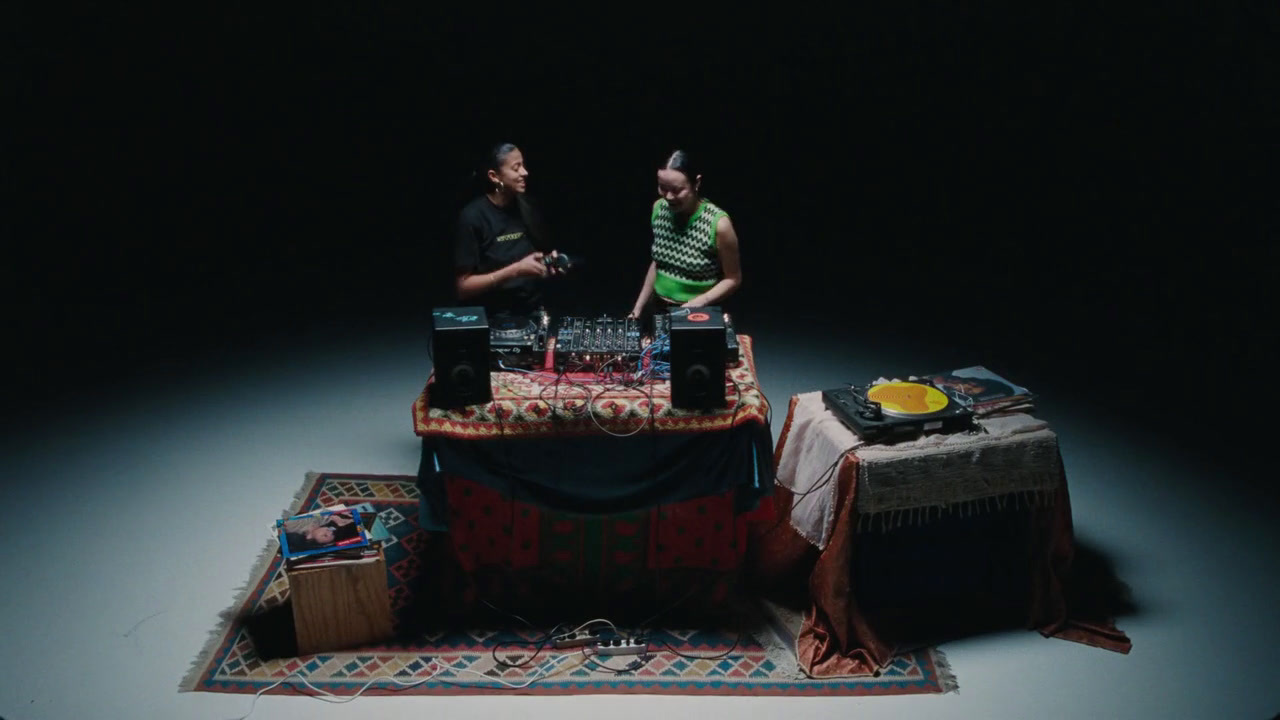 a couple of men standing next to a table