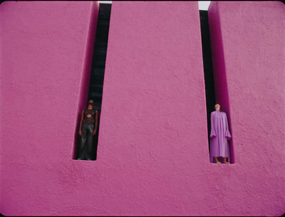 a couple of figurines are standing in a window