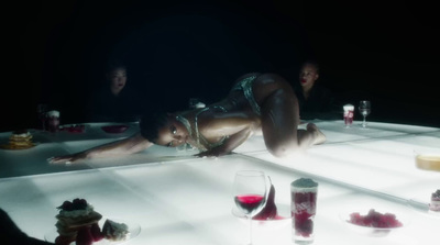 a woman laying on the floor in a dimly lit room