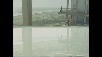 a couple of people standing on top of a beach