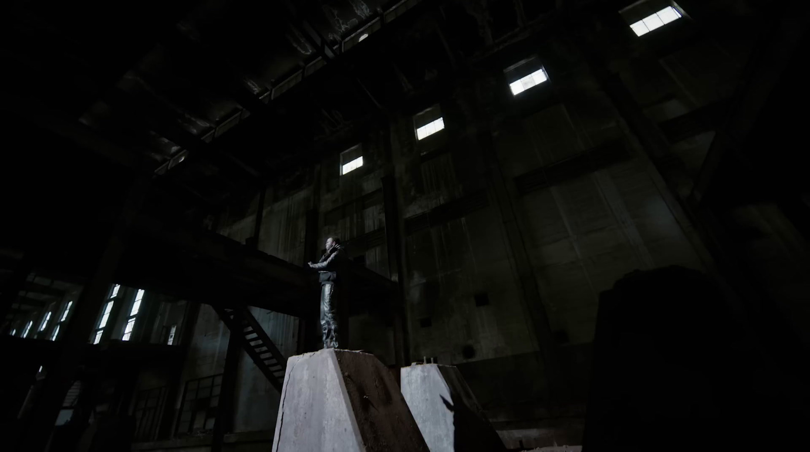 a man standing on top of a cement block