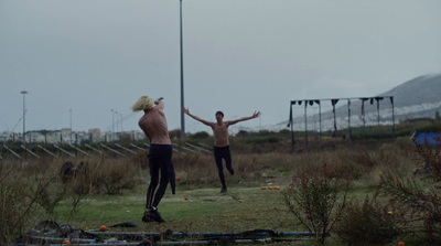 a couple of people that are standing in the grass