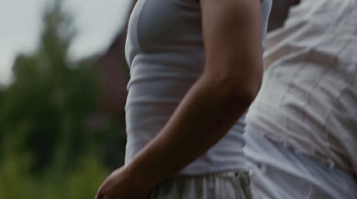 a woman in a white dress holding a white frisbee