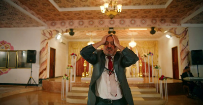 a man in a suit and tie standing in a room