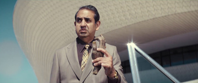 a man in a suit holding a snake in his hand