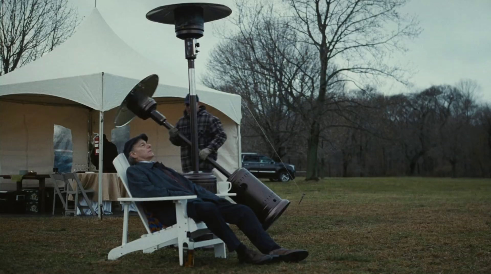 a man sitting in a chair holding a giant object