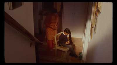 a man sitting on a chair next to a woman