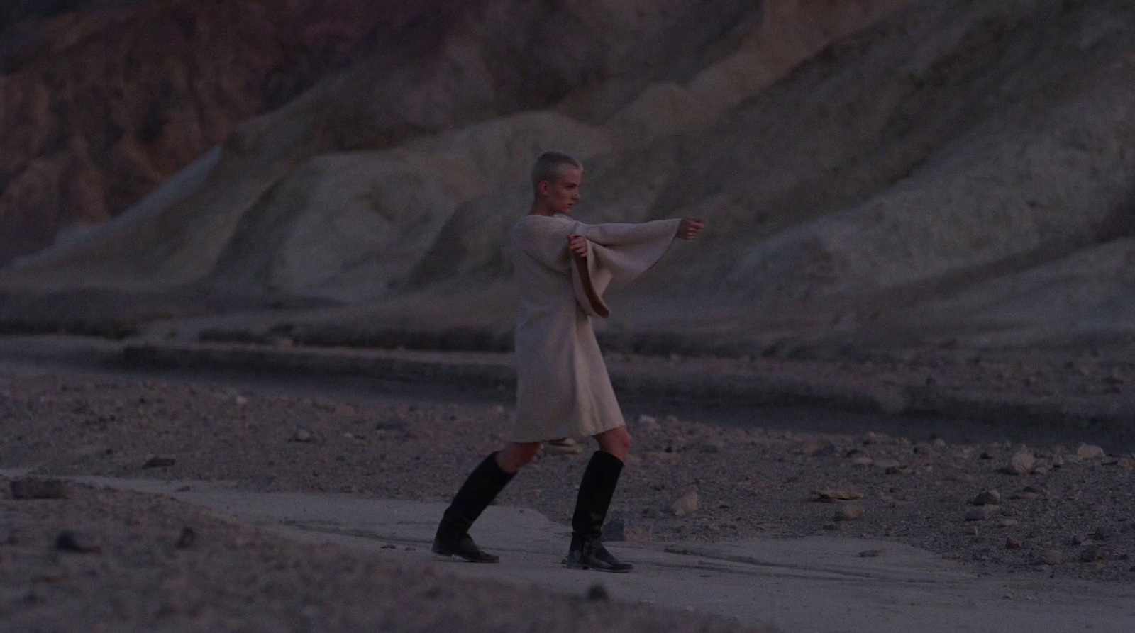 a man in a long white coat and black boots