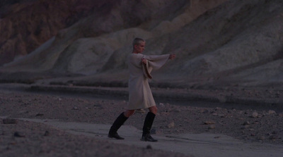 a man in a long white coat and black boots