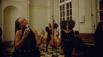 a group of women singing into a microphone