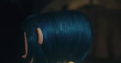 a close up of a person with blue hair