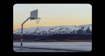 a basketball hoop in front of a snowy mountain