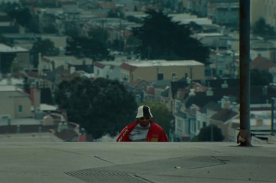 a man in a red jacket and a white hat