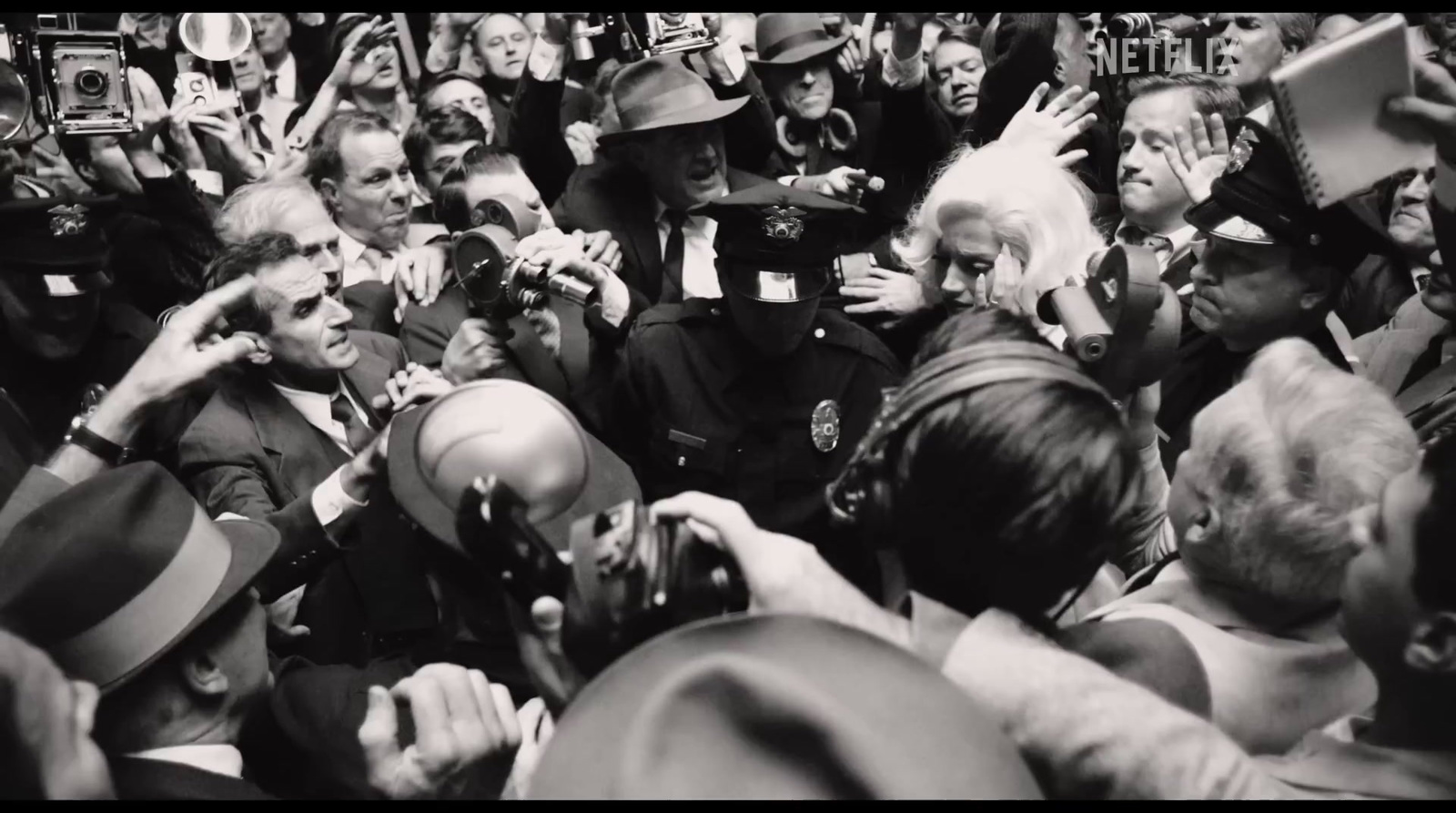 a crowd of people with cameras taking pictures