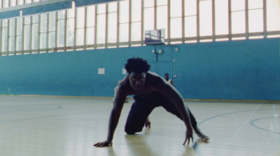 a man in black shirt and shorts playing a game of basketball