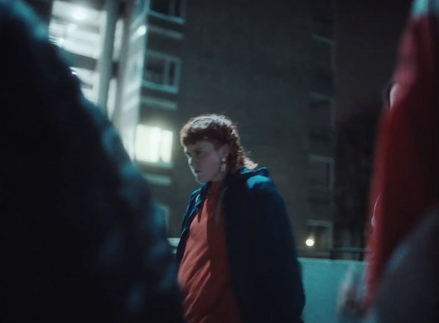 a man standing in front of a building at night