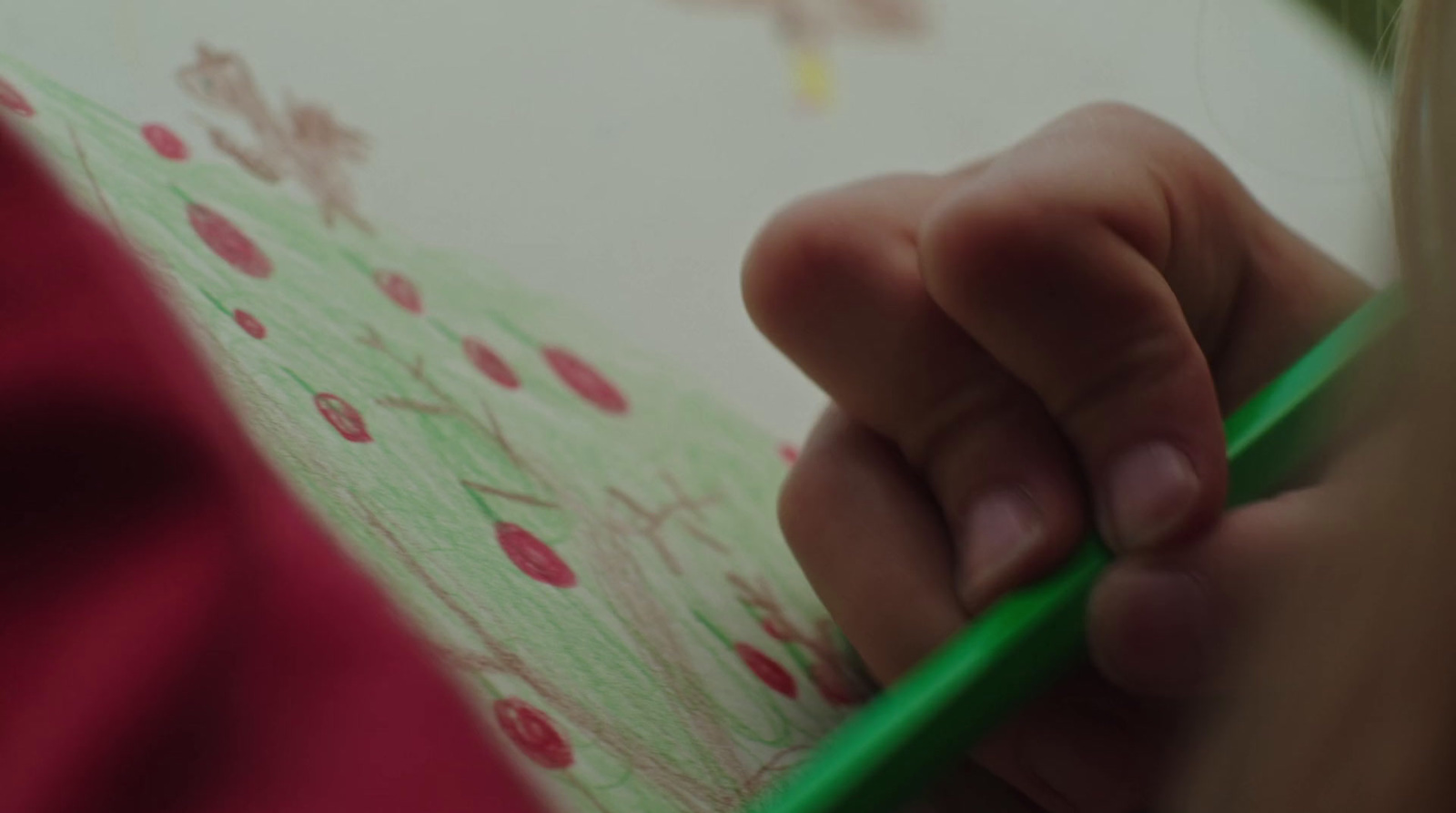 a close up of a person writing on a piece of paper