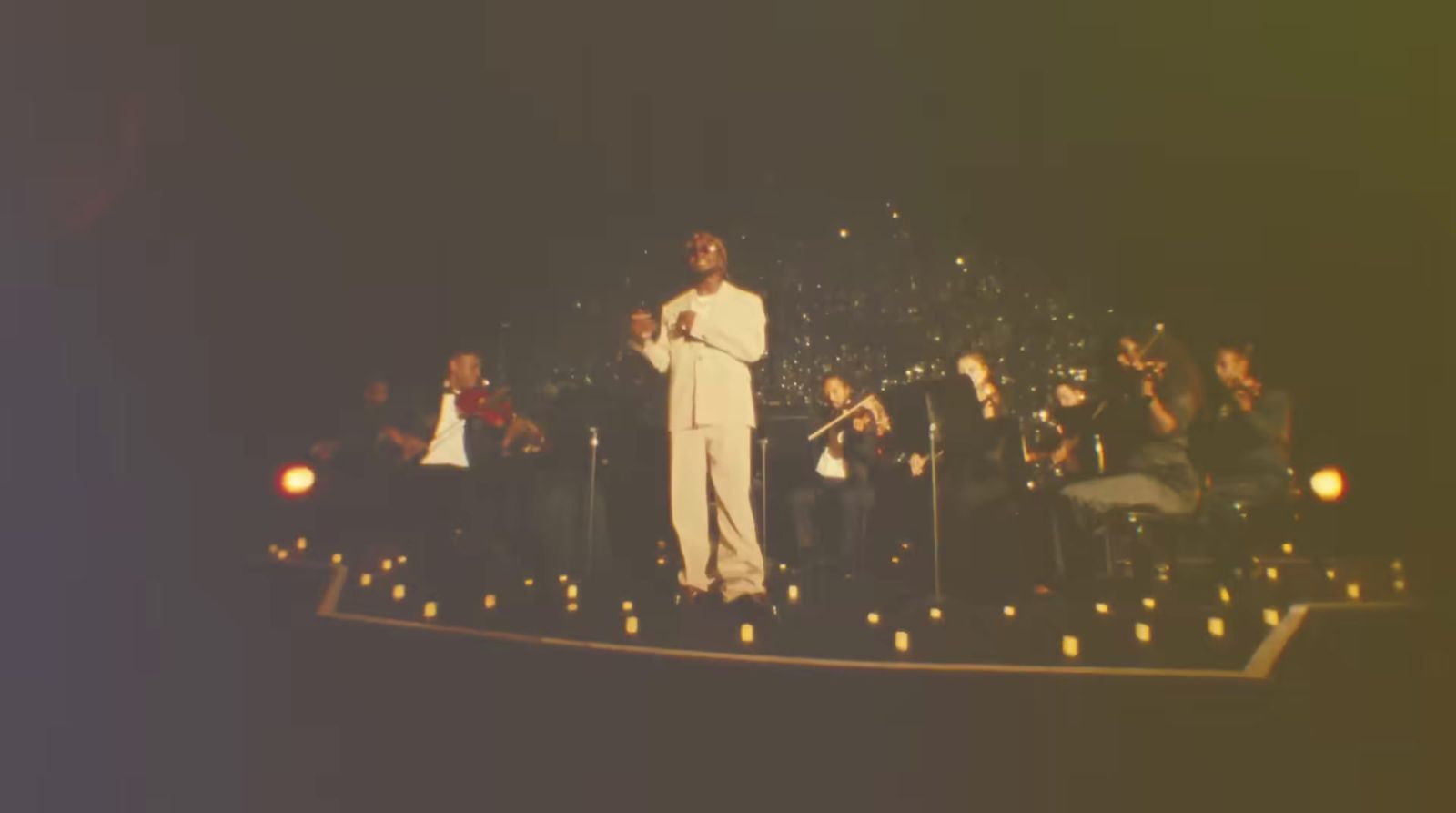 a man standing on top of a stage holding a microphone