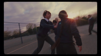 a couple of people riding skateboards down a street