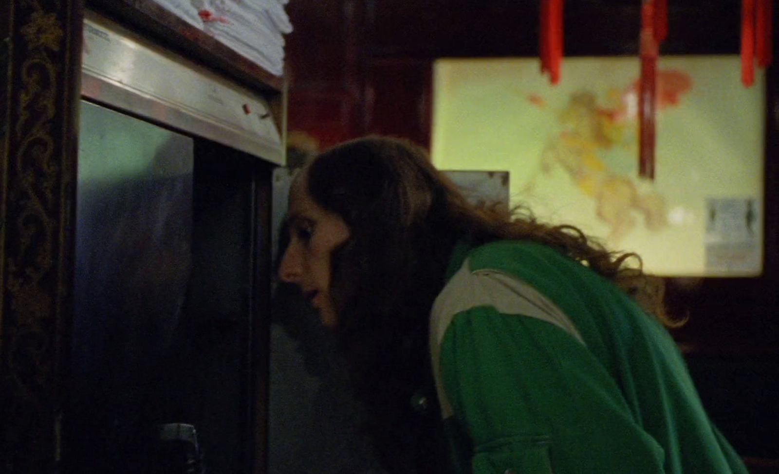 a woman with long hair looking into an oven