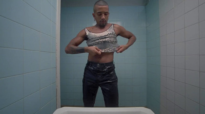 a man standing in front of a mirror in a bathroom