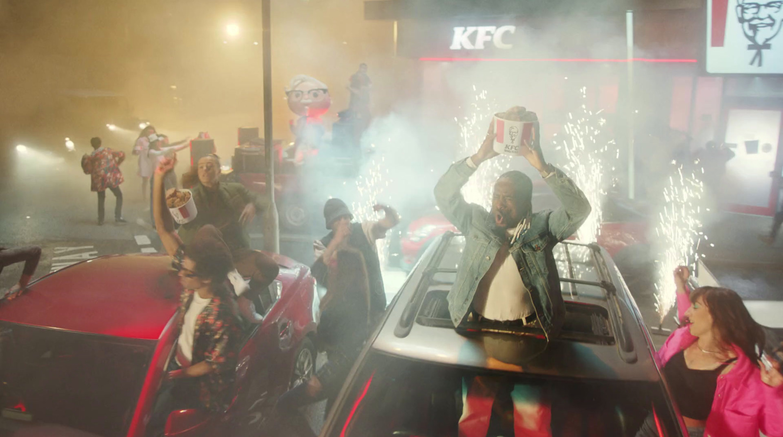 a group of people standing around a car