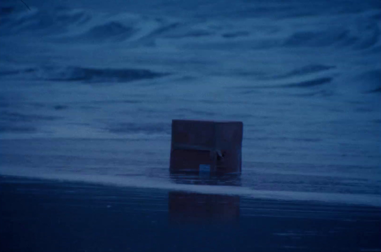 a box sitting in the middle of the ocean