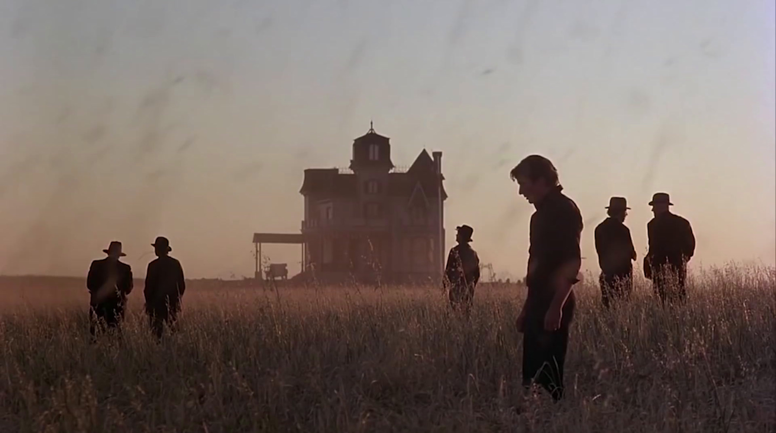 a group of people standing in a field