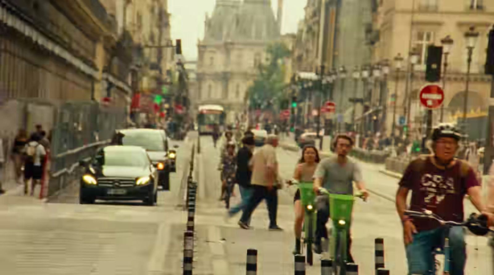 a group of people riding bikes down a street