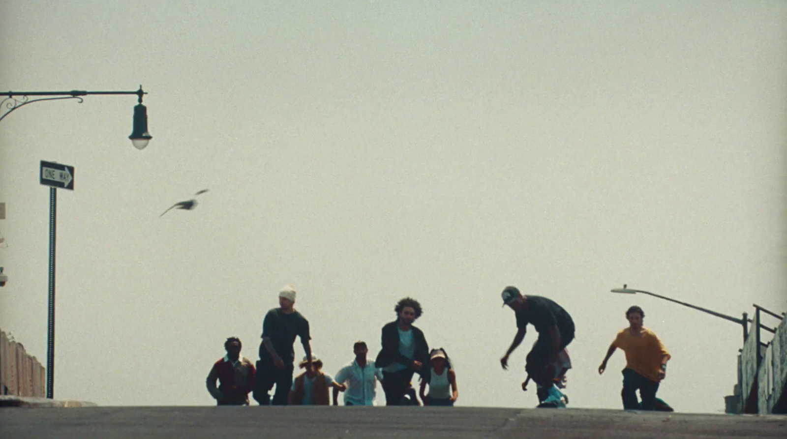 a group of young men riding skateboards down a street