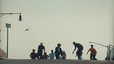 a group of young men riding skateboards down a street