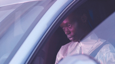 a man sitting in a car looking out the window