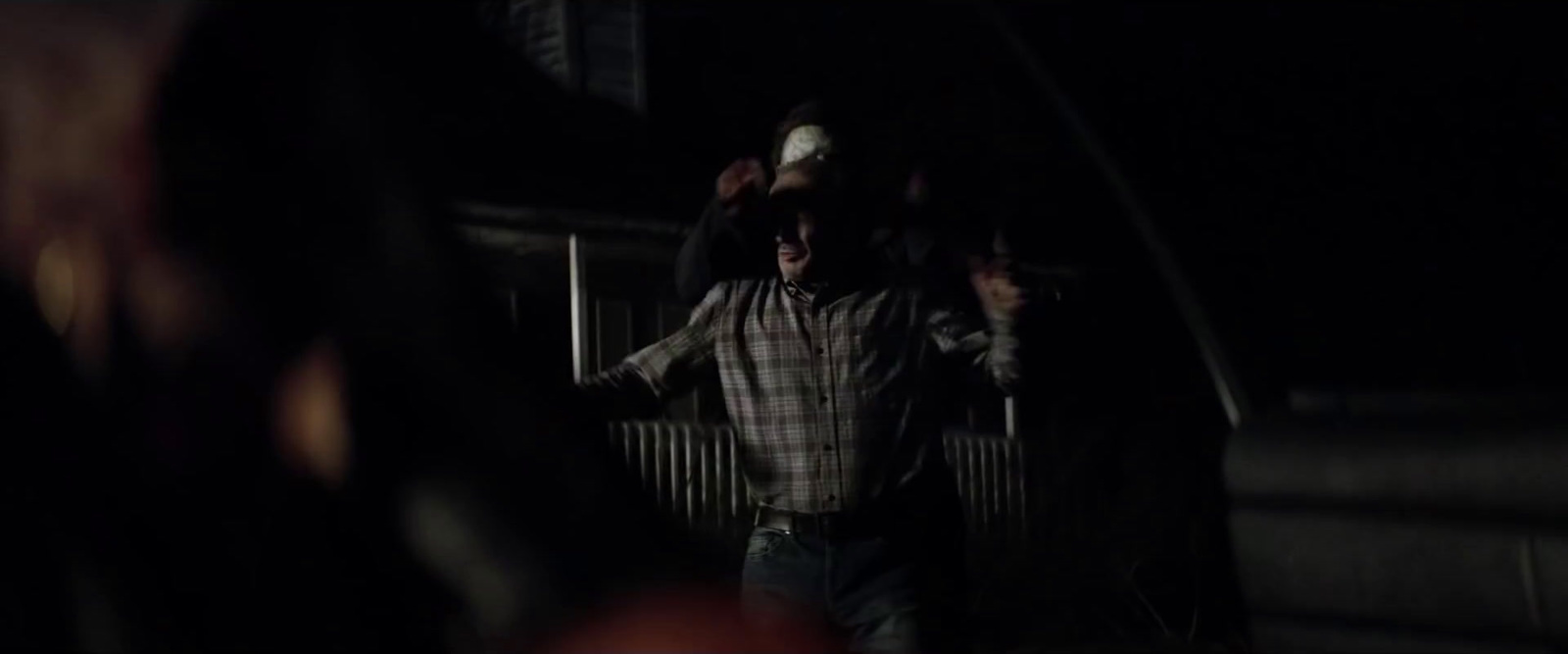 a man walking down a dark street at night