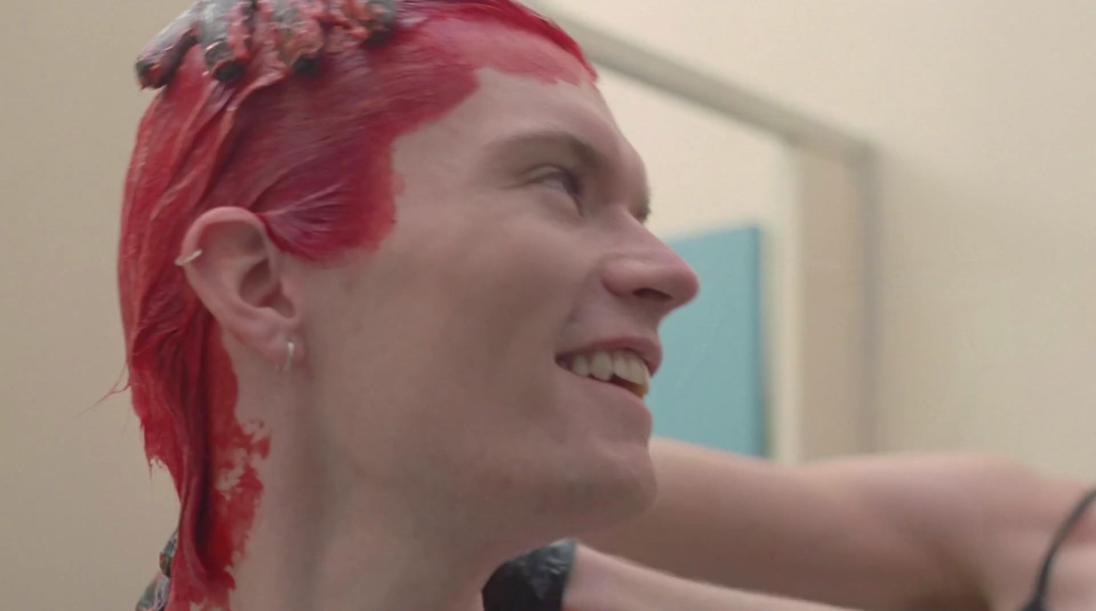 a woman with red hair is brushing her hair