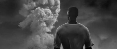 a man standing in front of a large plume of smoke