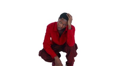 a man in a red suit crouching down