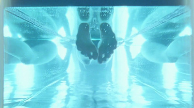 a person standing in front of a mirror with their feet in the water