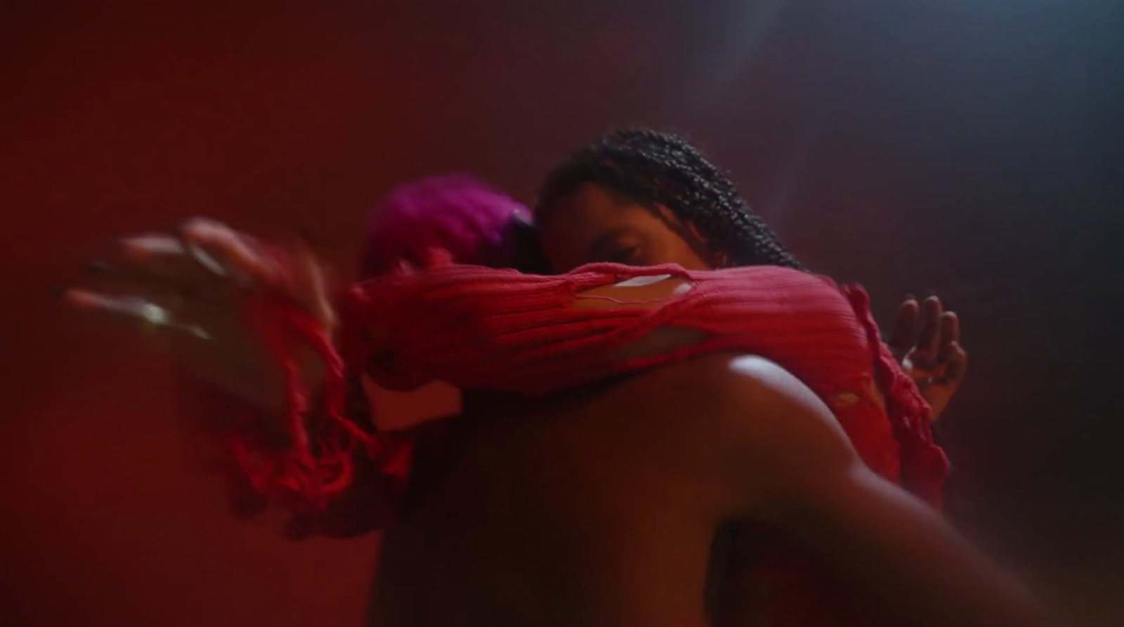 a woman in a red scarf is dancing