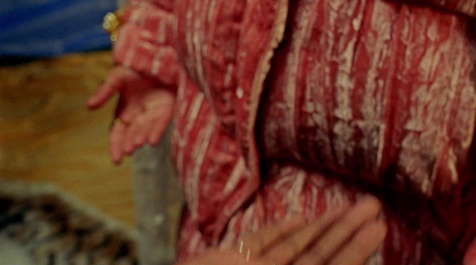 a close up of a person holding a piece of meat