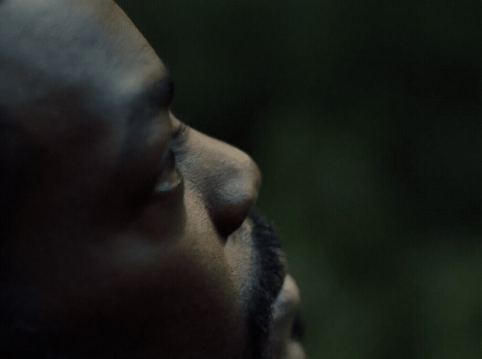 a close up of a man's face with a blurry background