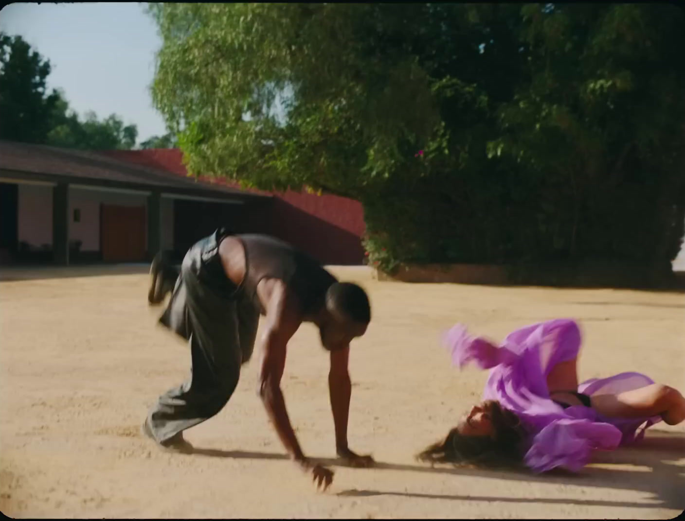 a man and a woman playing with a frisbee