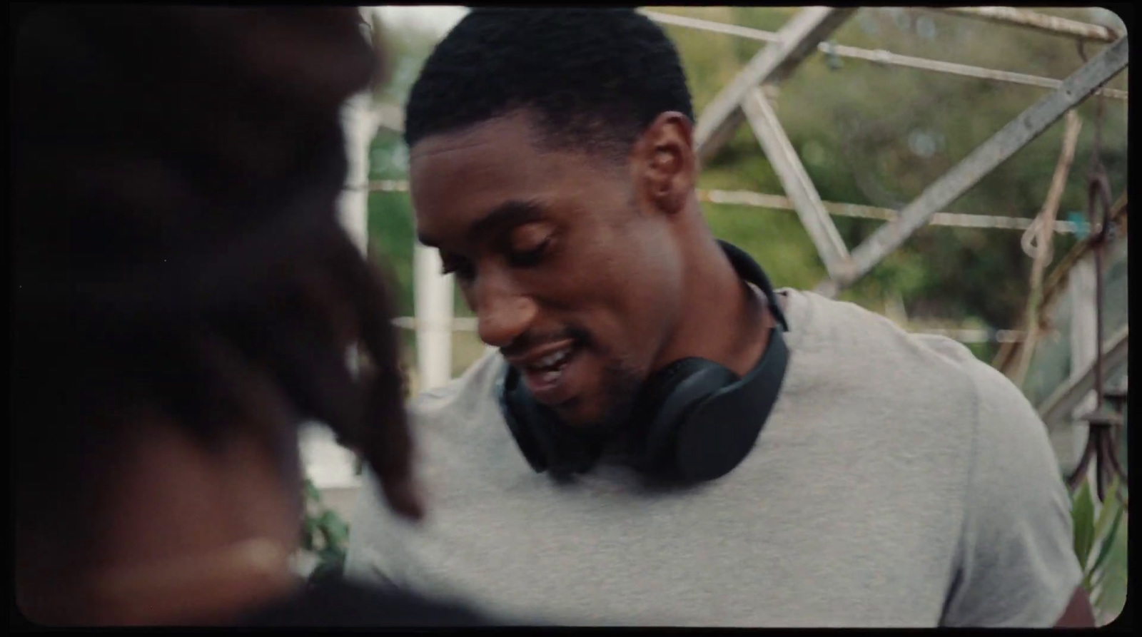 a man wearing headphones standing next to a woman